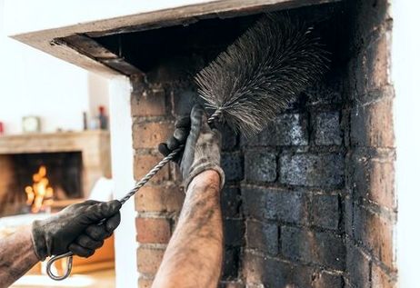 Wire-brushing and rebuilding a firebox in a Staten Island home